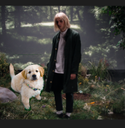 Porter Robinson standing next to a dog.